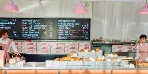 Staff at Baked Wonder in Burwood East wear frilly pink uniforms.