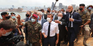 French President Emmanuel Macron inspects the site of the August 4 blast in Beirut.