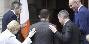 Irish Prime Minister Leo Varadkar,centre,leaves after announcing his resignation in Dublin,Ireland,on Wednesday.