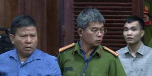 Chau Van Kham being escorted into a Vietnamese courtroom in 2019.