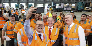 Opposition Leader Anthony Albanese takes a selfie with workers during a visit to the Toll NQX national office in Berrinba,Queensland.