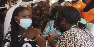 A Nigeria civil servant receives a dose of the AstraZeneca coronavirus vaccine.