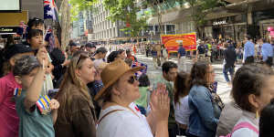 A crowd lines Brisbane’s Adelaide Street and pedestrian walkways to recognise Australian and New Zealand troops and their families on Anzac Day.