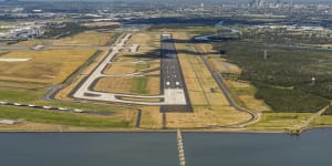 The new stretch of tarmac will be Brisbane Airport's third runway,but an existing one (bottom left) has been clogged by parked Virgin Australia aircraft in recent months.