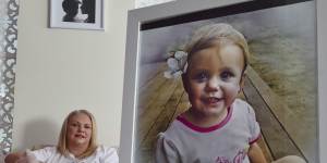 Allison Burns,OAM,with a photo of her daughter,Bella Rees,who died after swallowing a button battery.