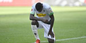 Marcus Thuram takes a knee during Borussia Moenchengladbach's 4-1 win over Union Berlin.