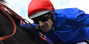 Hugh Bowman rides Flit to a three-way photo finish win at the Thousand Guineas.