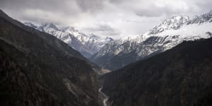 The Sutlej River flows in the valley below the tall snowy peaks in the Kinnaur district of the Himalayan state of Himachal Pradesh,India.
