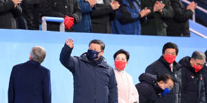 Xi Jinping,President of China,waves at the crowd during the opening ceremony. 