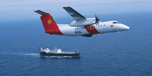 A Cobham Dash 8 aircraft,pictured above a Border Force ship,conducts aerial surveillance.