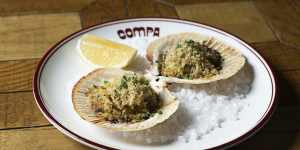 Lightly cooked Abrolhos Island scallops are served on the shell with herb butter. 