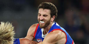 The Lions’ Kai Lohmann is tackled by Bulldogs champion Marcus Bontempelli.