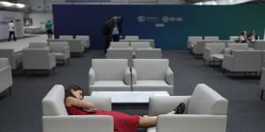 A woman rests as negotiations at COP28 in Dubai went into the night on Monday.