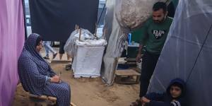 Displaced Palestinians cook food in a temporary shelter at a camp in Gaza.