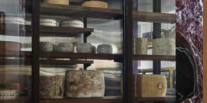 A wall of cheese greets diners when they arrive.
