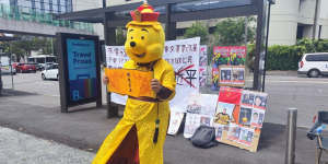 Chinese international student Aaron dressed as Winnie the Pooh as part of his protest against Chinese president Xi Jinping at a bus stop outside the entrance to the University of Sydney in February 2023.