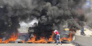 Demonstrators block Lebanon's main Mediterranean highway on Sunday. 