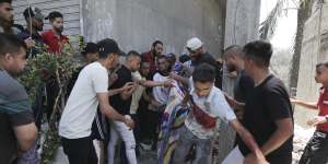 Palestinians evacuate dead and wounded after an Israeli bombardment of Deir al-Balah in the Gaza Strip on Saturday.