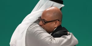 United Nations Climate Chief Simon Stiell,right,and COP28 President Sultan al-Jaber embrace at the COP28