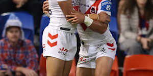 Tyrell Sloan and Val Holmes celebrate a Dragons try.