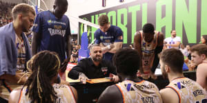 Taipans players are addressed by their coach during a game on Wednesday.