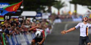 Emil Herzog of Germany celebrates at finish line near Wollongong’s City Beach,as winner of the junior road race.