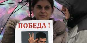 A woman holds up a picture of Novak Djokovic during a protest in Belgrade,Serbia,over the tennis player’s detention.