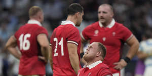 Wales players react after losing the Rugby World Cup quarterfinal match against Argentina.