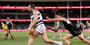 A lunging Travis Boak in pursuit of Cat Patrick Dangerfield in the qualifying final between Port Adelaide and Geelong.