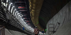 A worker walks through one of the twin tunnels being constructed under Rosehill Racecourse near Parramatta.