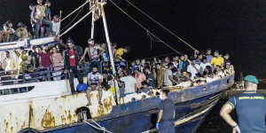 A fishing boat with migrants is docked at the port of the Sicilian island of Lampedusa,southern Italy,in September 2021. 