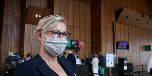  A staff member wears a mask as she greets guests arriving for the Don Burrows:A Celebration of Life Through Jazz.