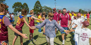 Rosie Batty leads the teams out on Tyabb Oval through a guard of honour at a football match in his honor.