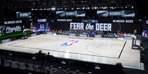 Officials stand beside an empty court after the scheduled start of game five between the Milwaukee Bucks and the Orlando Magic. 