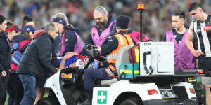 Brayden Maynard watches on as Angus Brayshaw is stretchered off the field.