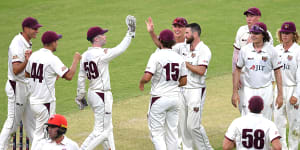 Queensland bowler Michael Neser (centre) celebrates dismissing South Australian batsman Harry Nielsen (left) for nought on day 1 of the Round 9 Sheffield Shield match at The Gabba on Monday.