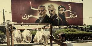 In Lebanon’s capital,Beirut,a food cart vendor passes a billboard showing assassinated leaders including Hamas’ Ismail Haniyeh,General Qasem Soleimani of the Iranian Revolutionary Guard,and Hezbollah commander Fuad Shukr.