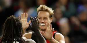 Anthony McDonald-Tipungwuti and Darcy Parish celebrate a goal during the Bombers’ clash with the Dockers at Marvel Stadium.