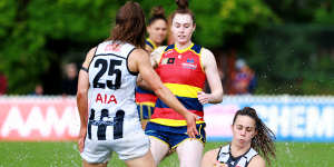 Football or swimming? Collingwood’s Chloe Molloy takes a sliding mark against Adelaide.