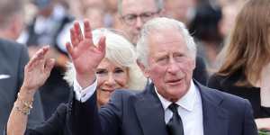 King Charles III and Camilla,Queen Consort wave after viewing floral tributes to the late Queen Elizabeth II outside Buckingham Palace on September 09,2022 in London,United Kingdom. 