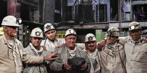 Miners hold the last lump of coal during a closing ceremony of the last German coal mine Prosper-Haniel in Bottrop on December 21,2018. 