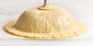 The pithivier is now ready to be baked. (The chimney tube keeps the gravy hole open as the pithivier bakes.)