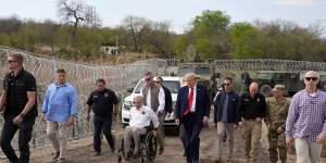 Governor Greg Abbott (in wheelchair) and Donald Trump at Shelby Park in Eagle Pass,on the US-Mexico border.