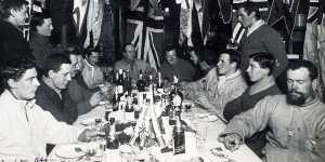 Explorer Robert Scott and his team enjoy a mid-winter dinner in June 1911.