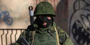 An unidentified soldier stands near a Ukrainian military base in Simferopol. 
