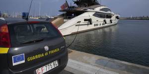 An Italian police car parked in front of Russian oligarch Alexei Mordashov’s yacht Lady M. 