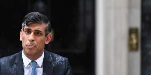 British Prime Minister Rishi Sunak gets drenched as he announces the election on Wednesday.