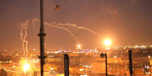 A US army Apache helicopter launches flares as a show of presence while conducting flights over the US Embassy in Baghdad,Iraq.