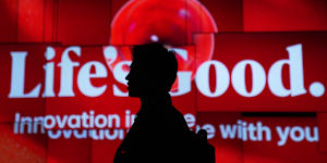 A person walks past screens at the LG Electronics booth during the CES tech show Tuesday,Jan. 6,2026,in Las Vegas. (AP Photo/Abbie Parr)