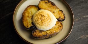 Royal blue potatoes topped with a cloud of mustard foam.